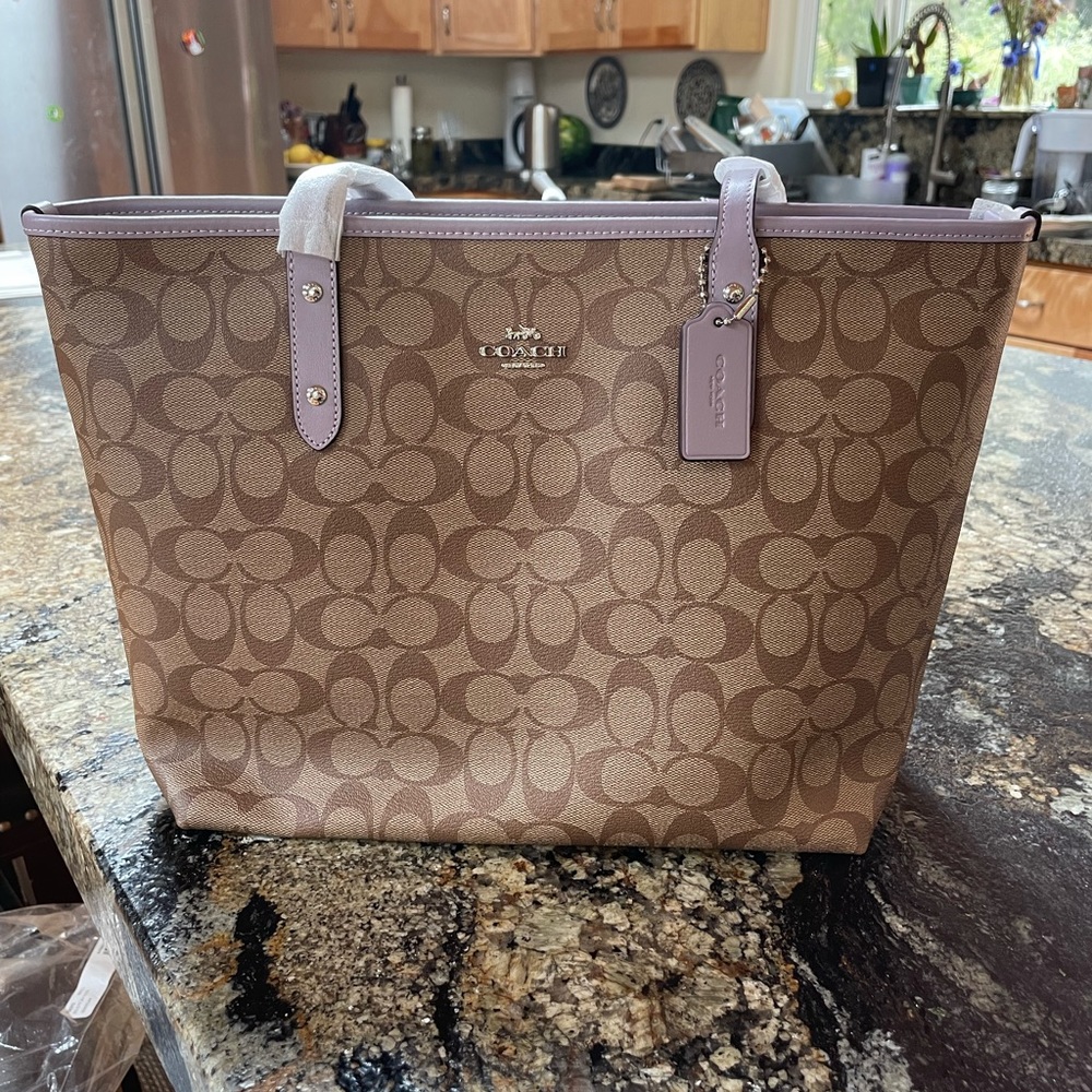 Cute leather signature city zip tote.